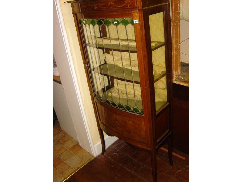 Appraisal: An inlaid Edwardian mahogany bow fronted display cabinet enclosed by