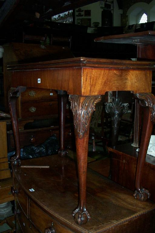 Appraisal: A George III mahogany fold over top card table of