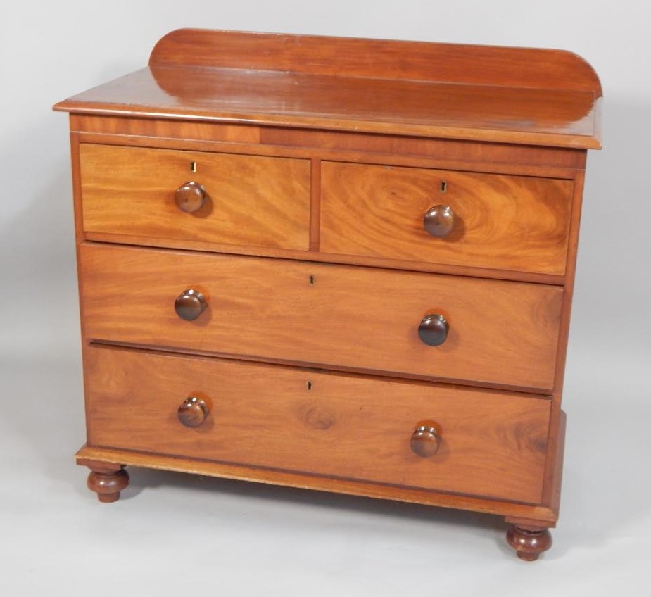 Appraisal: A Victorian mahogany chest of drawers with a raised back