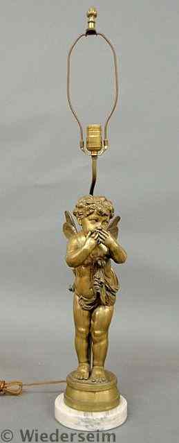 Appraisal: Brass putti lamp mounted on a circular base h to