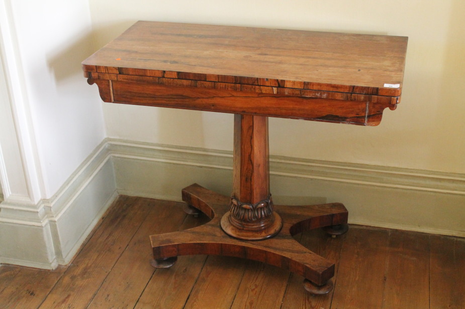 Appraisal: A Victorian rosewood card table with rectangular folding baize top