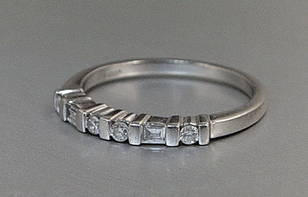 Appraisal: PLATINUM AND DIAMOND ETERNITY WEDDING BAND Platinum band contains round