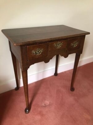 Appraisal: A George III oak lowboy with over hanging top three