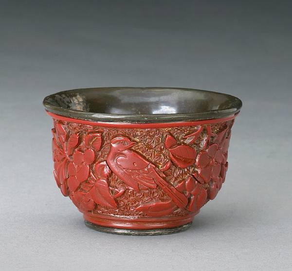 Appraisal: A cinnabar lacquer and silvered metal cup th Century Of