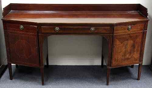 Appraisal: A George III mahogany sideboard of idiosyncratic form the three-quarter