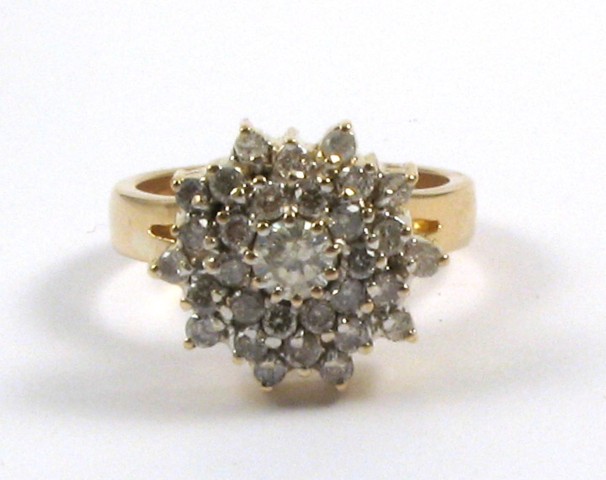 Appraisal: DIAMOND AND TWELVE KARAT GOLD RING centering a round brilliant-cut