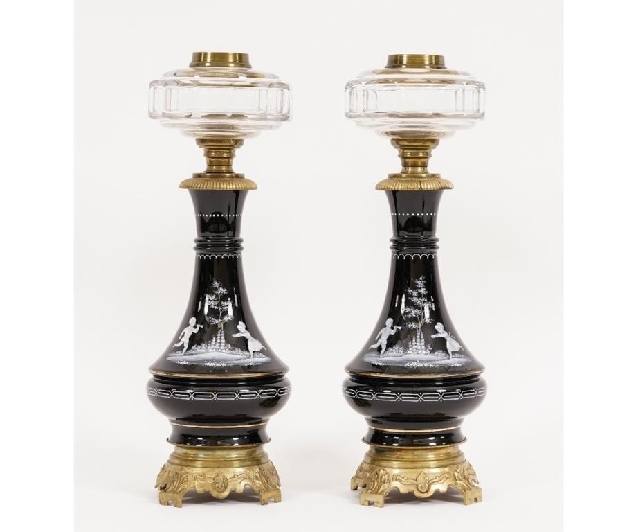 Appraisal: Pair of Mary Gregory black oil lamps with clear glass