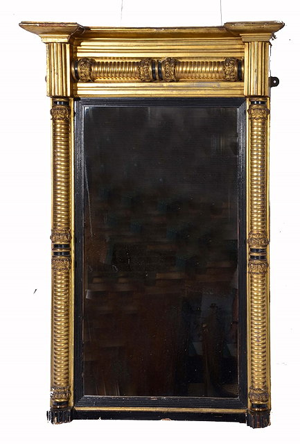 Appraisal: A GEORGE IV GILTWOOD HANGING WALL MIRROR with ebonised slip