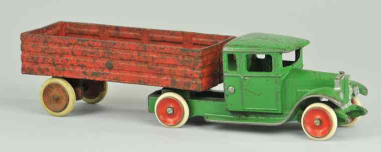 Appraisal: SCOGLUND OLSON TRUCK WITH OPEN TRAILER Green enclosed cast iron