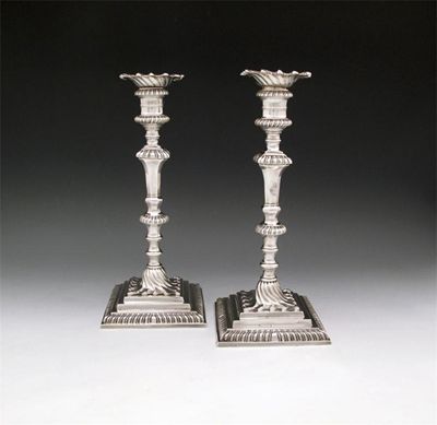 Appraisal: A pair of George III cast silver candlesticks by Jonathan