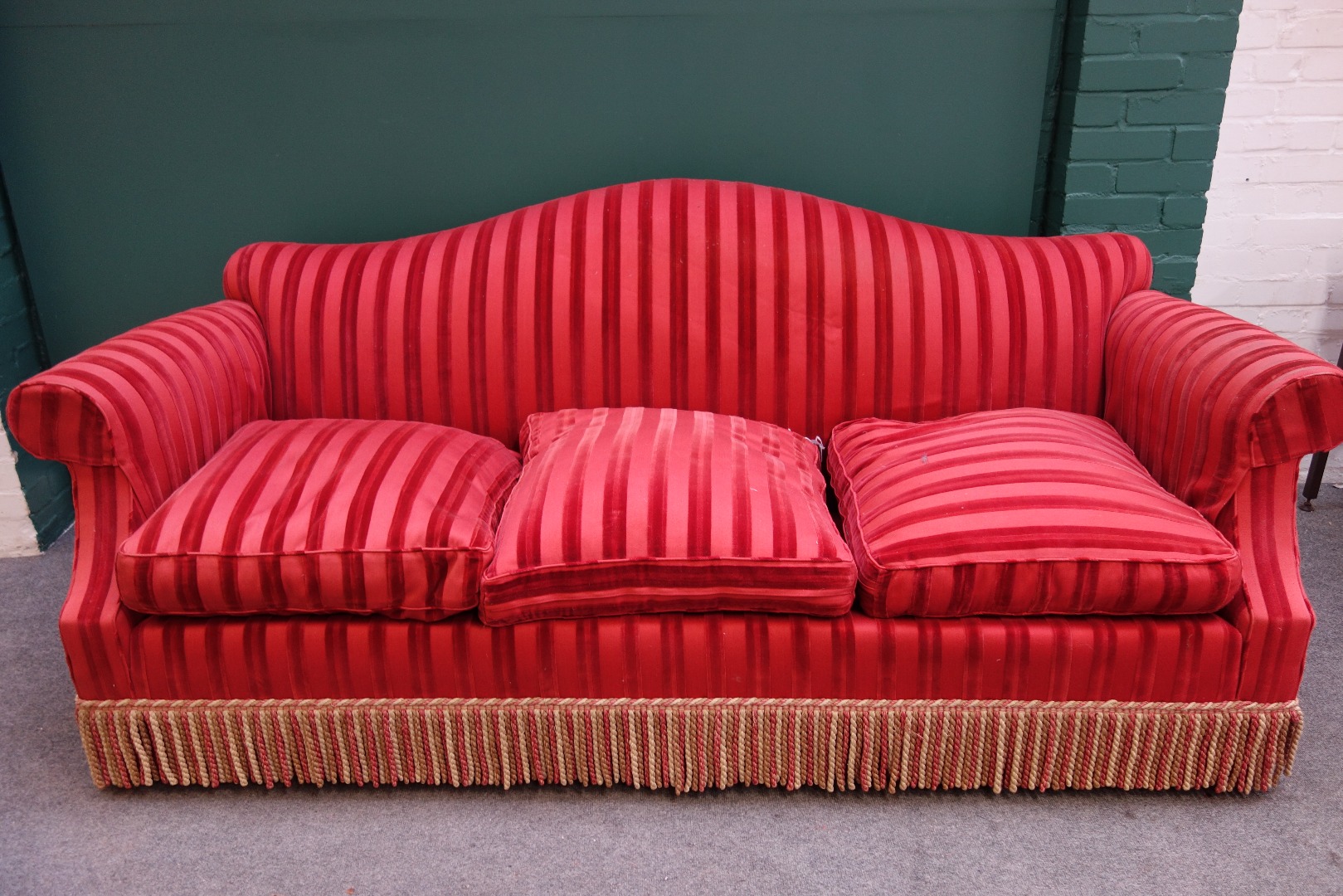 Appraisal: Kingcome Sofa Ltd a th century striped red upholstered hump