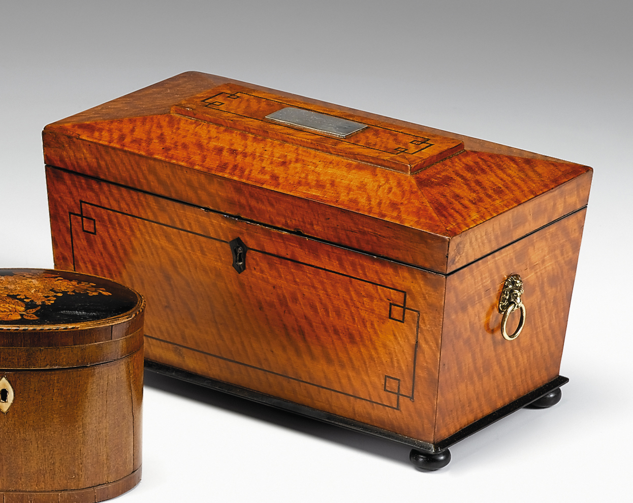 Appraisal: English ebony inlaid satinwood caddy st quarter th century The