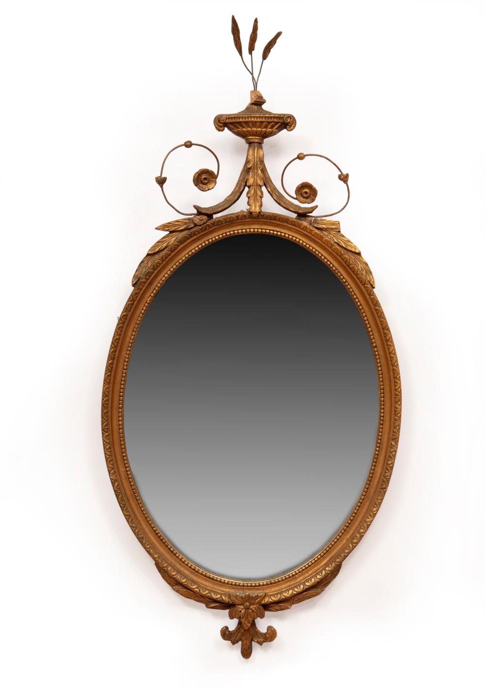 Appraisal: Neoclassical-Style Giltwood Oval Mirror surmounted by an urn and foliate