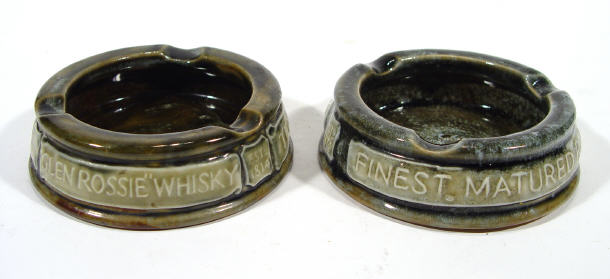 Appraisal: Two Royal Doulton stoneware advertising ashtrays with raised lettering produced