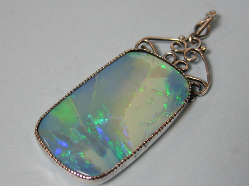 Appraisal: A large oblong Pendant set opal with silver surround having