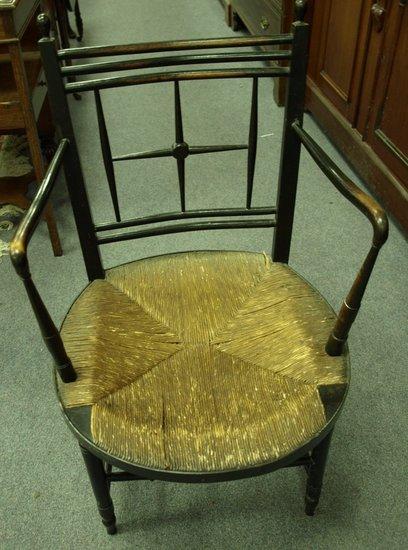 Appraisal: A Victorian ebonised armchair the back with cross shaped splat