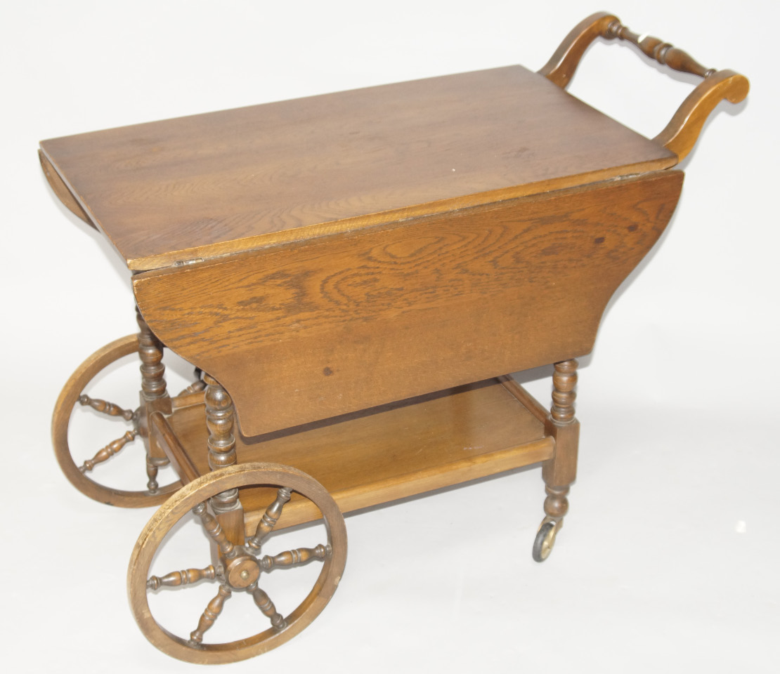 Appraisal: A oak two tier tea trolley with two fall leaves