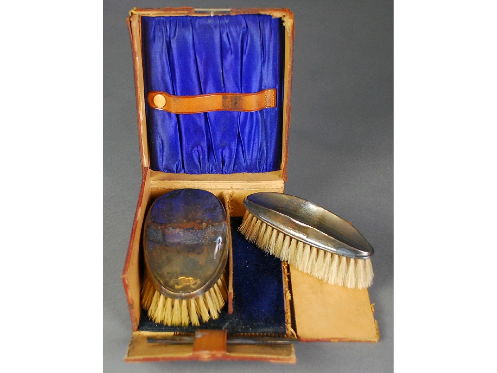 Appraisal: CASED SET OF TWO GEORGE V SILVER CLAD MILITARY BRUSHES