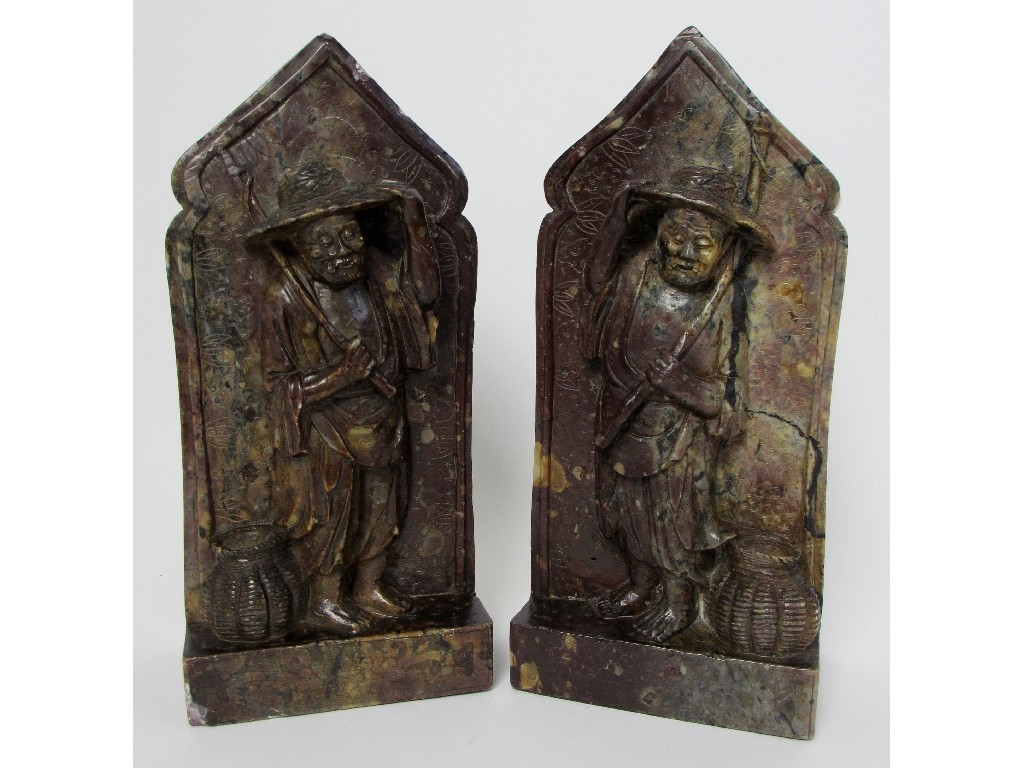 Appraisal: A pair of Chinese soapstone carved bookends each with figures