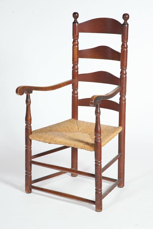 Appraisal: LADDERBACK ARMCHAIR American early th century maple Sausage turnings scrolled