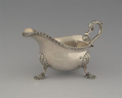 Appraisal: A late George II sauceboat on three shell feet with