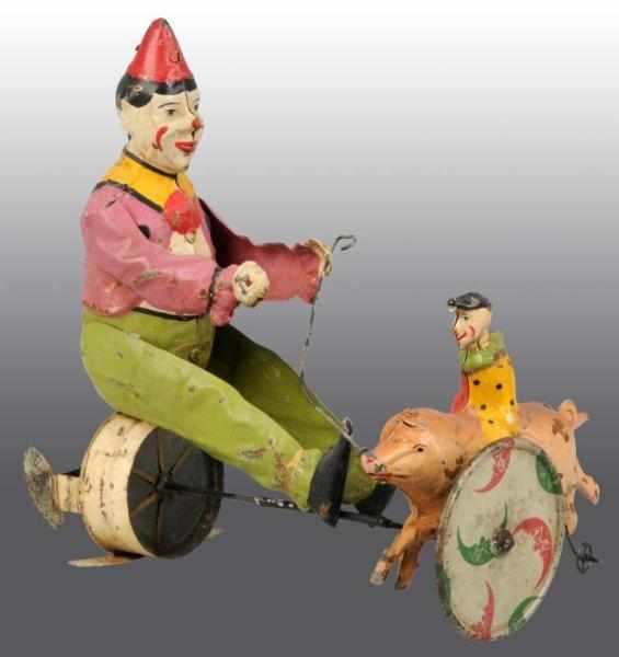 Appraisal: Tin Hand-Painted Clowns Pig Wind-Up Toy Description German s Possibly