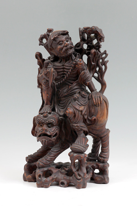 Appraisal: CHINESE CARVED WOOD FIGURE ON MAN ON TEMPLE LION Mythical