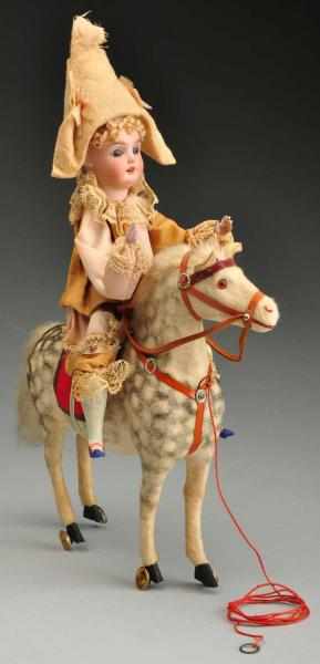 Appraisal: Bisque Head Clown on Horse Pull Toy Description Bisque head