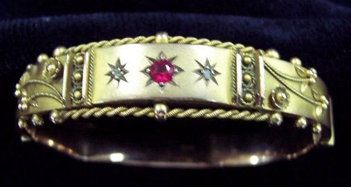 Appraisal: A hinged ct gold bangle with raised decoration having a