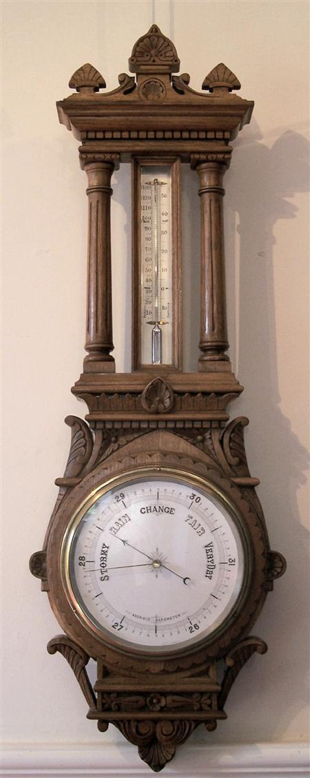 Appraisal: A large late Victorian carved oak aneroid barometer cm high