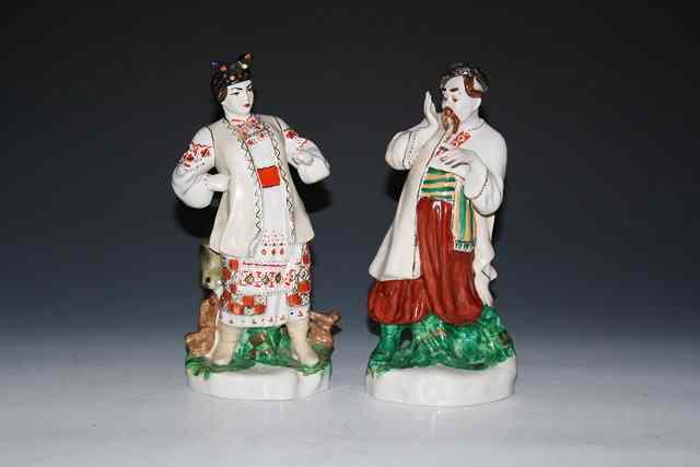 Appraisal: A PAIR OF RUSSIAN PORCELAIN FIGURES of a man and