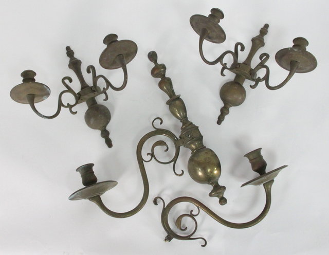 Appraisal: A Dutch brass two-branch wall light with split baluster column