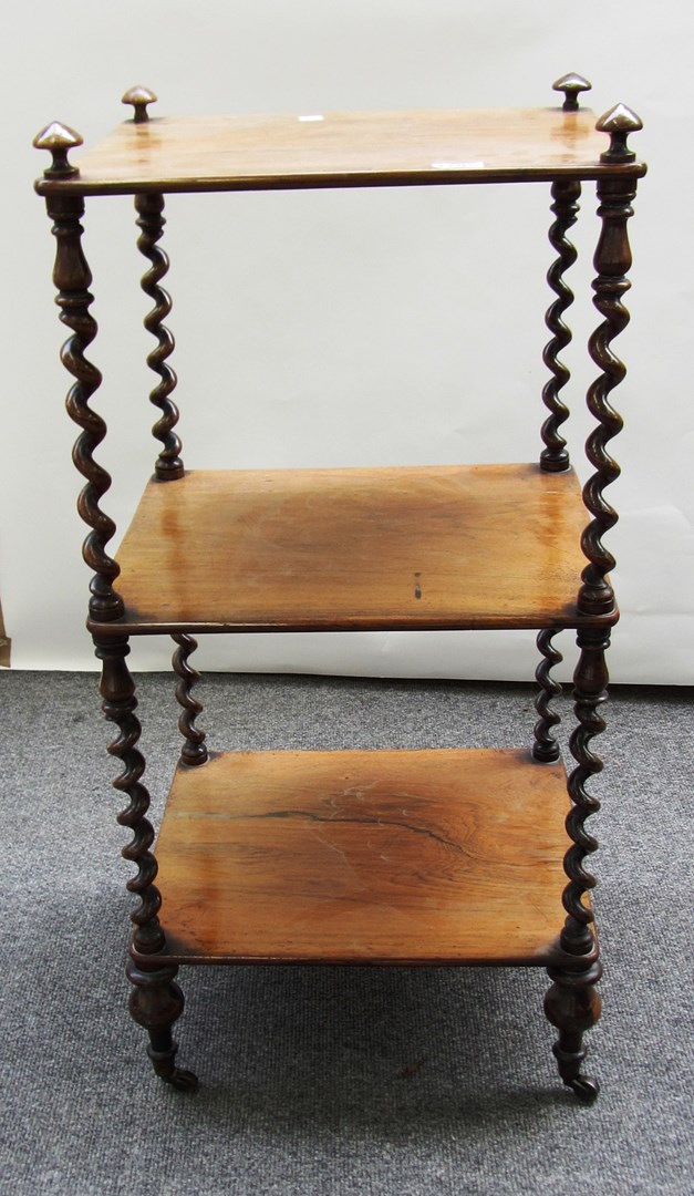 Appraisal: A Victorian rosewood three tier whatnot on slender barley-twist supports