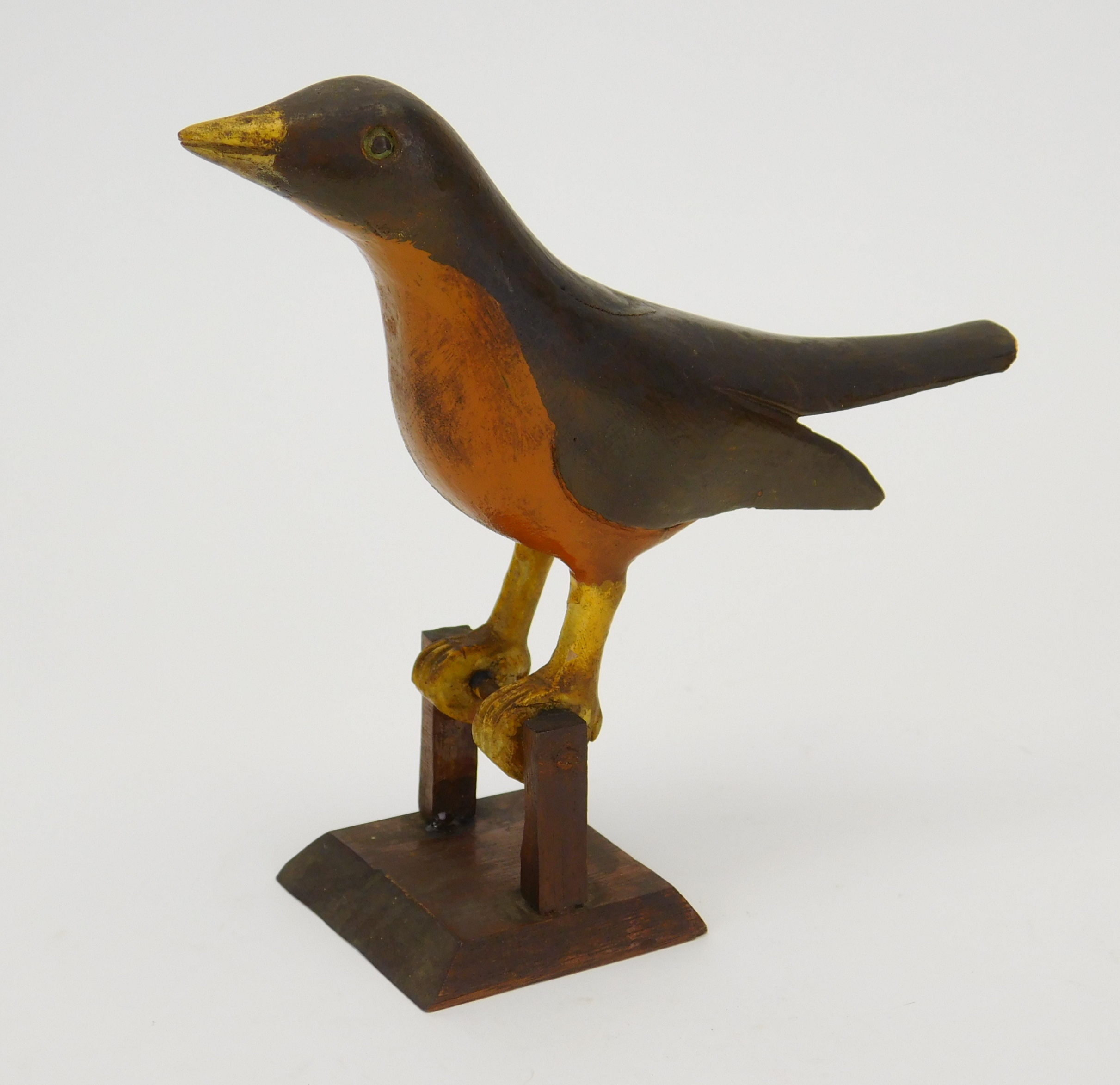 Appraisal: Folk art carved and painted wood bird on perch ''h