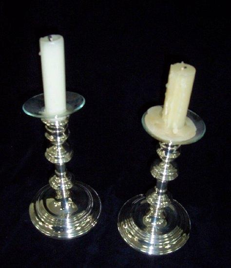 Appraisal: A pair of candlesticks the circular nozzles over knopped stems