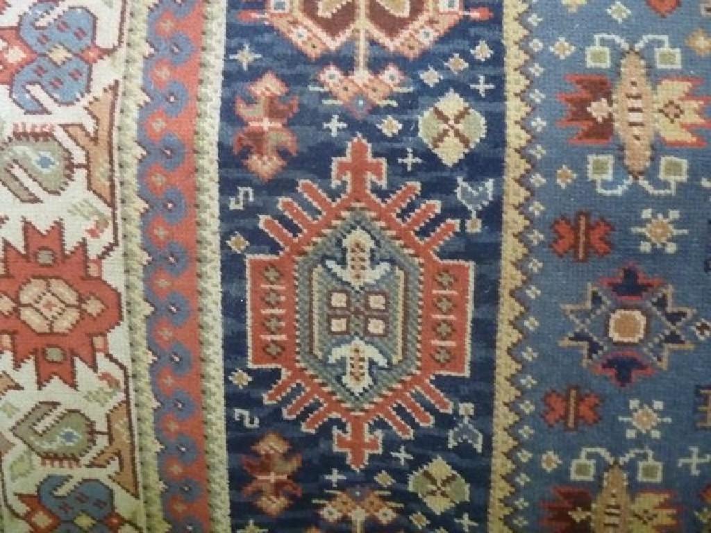 Appraisal: A wool carpet in the Persian style with multi-geometric centre