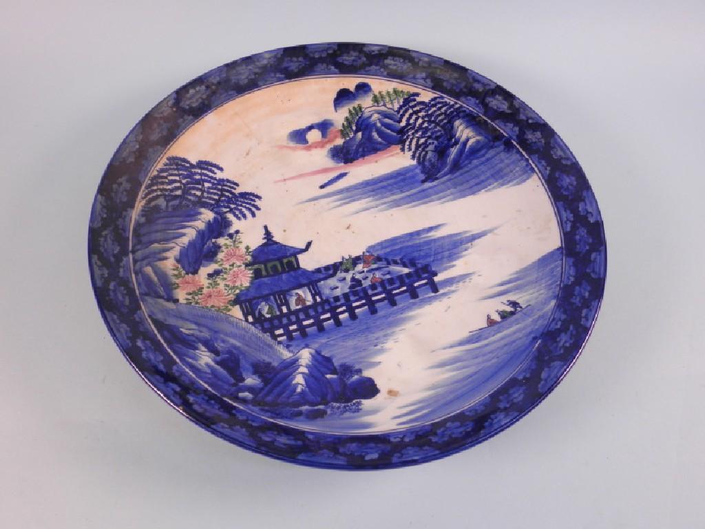 Appraisal: A Japanese blue and white charger decorated with a river