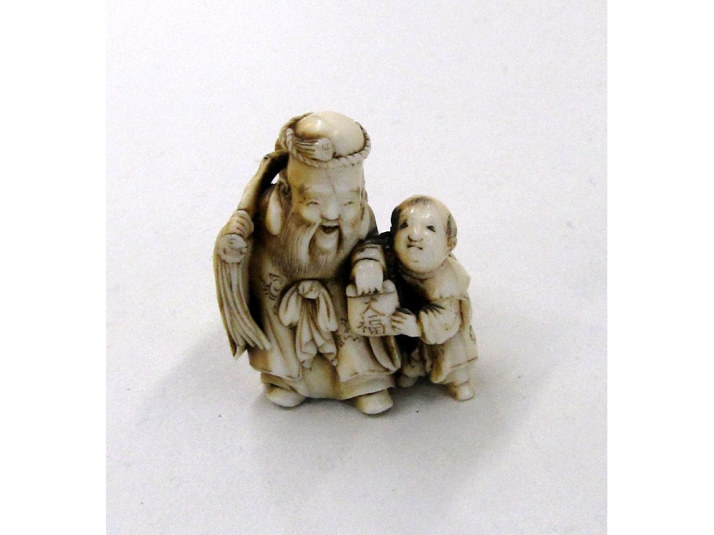 Appraisal: Japanese ivory Netsuke man and boy