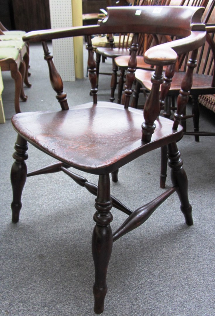 Appraisal: A th century elm seated bow back captains chair on