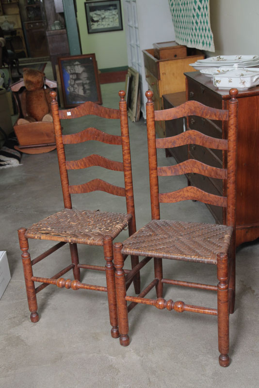 Appraisal: PAIR OF LADDERBACK CHAIRS Figured maple with rush seats and