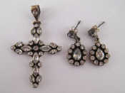 Appraisal: A white metal tests silver cross pendant set with clear