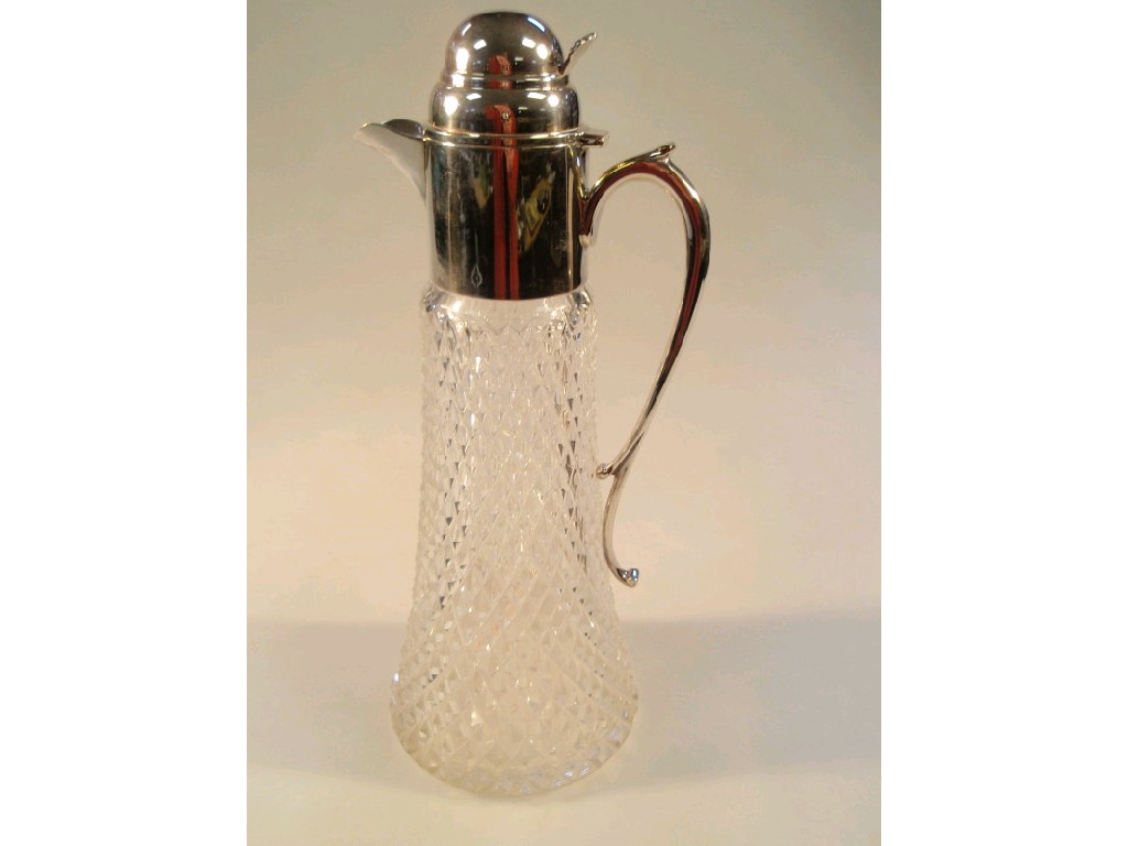 Appraisal: A glass claret jug with multi faceted tapered body and