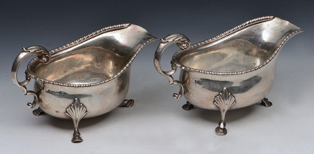 Appraisal: A PAIR OF SILVER SAUCE BOATS with gadrooned and shell