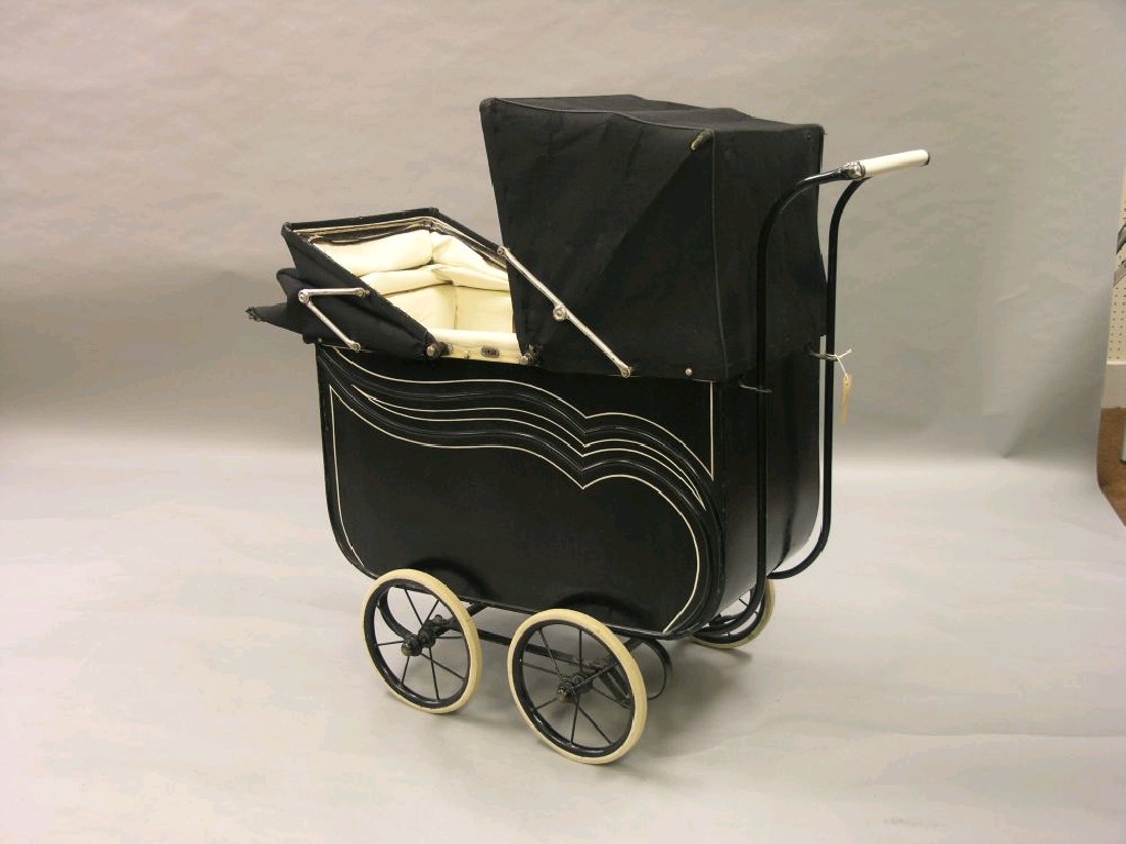 Appraisal: A 's doll's pram finished in black with white lining