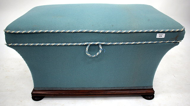 Appraisal: A BLUE UPHOLSTERED OTTOMAN STOOL of sarcophagus form and standing