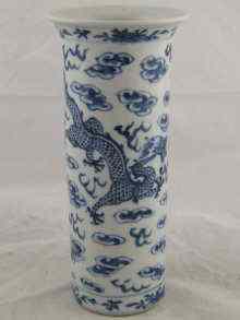 Appraisal: A Chinese cylindrical blue and white ceramic vase with dragons