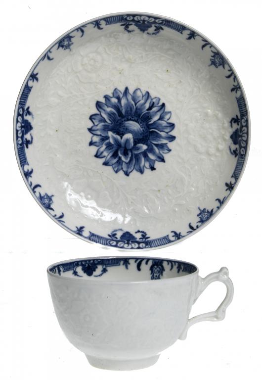 Appraisal: A FIRST PERIOD WORCESTER CHRYSANTHEMUM MOULDED TEACUP AND SAUCER painted