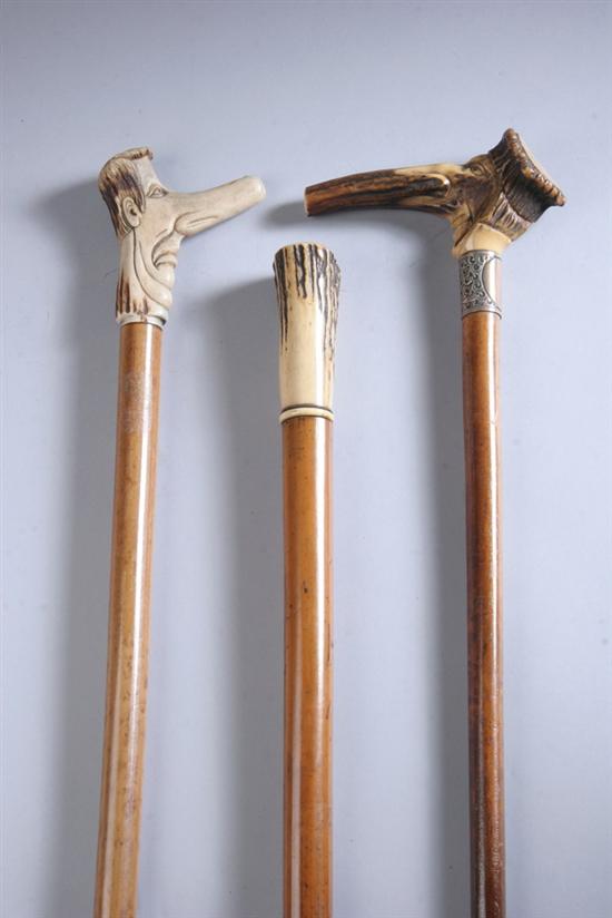 Appraisal: THREE STAG-HANDLED CANES One in on malacca shaft one carved