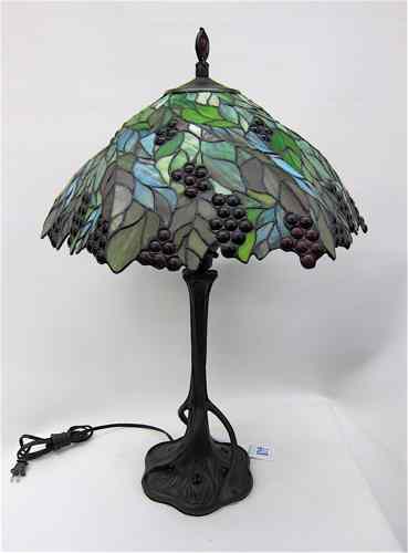 Appraisal: A STAINED AND LEADED GLASS TABLE LAMP with colorful jeweled