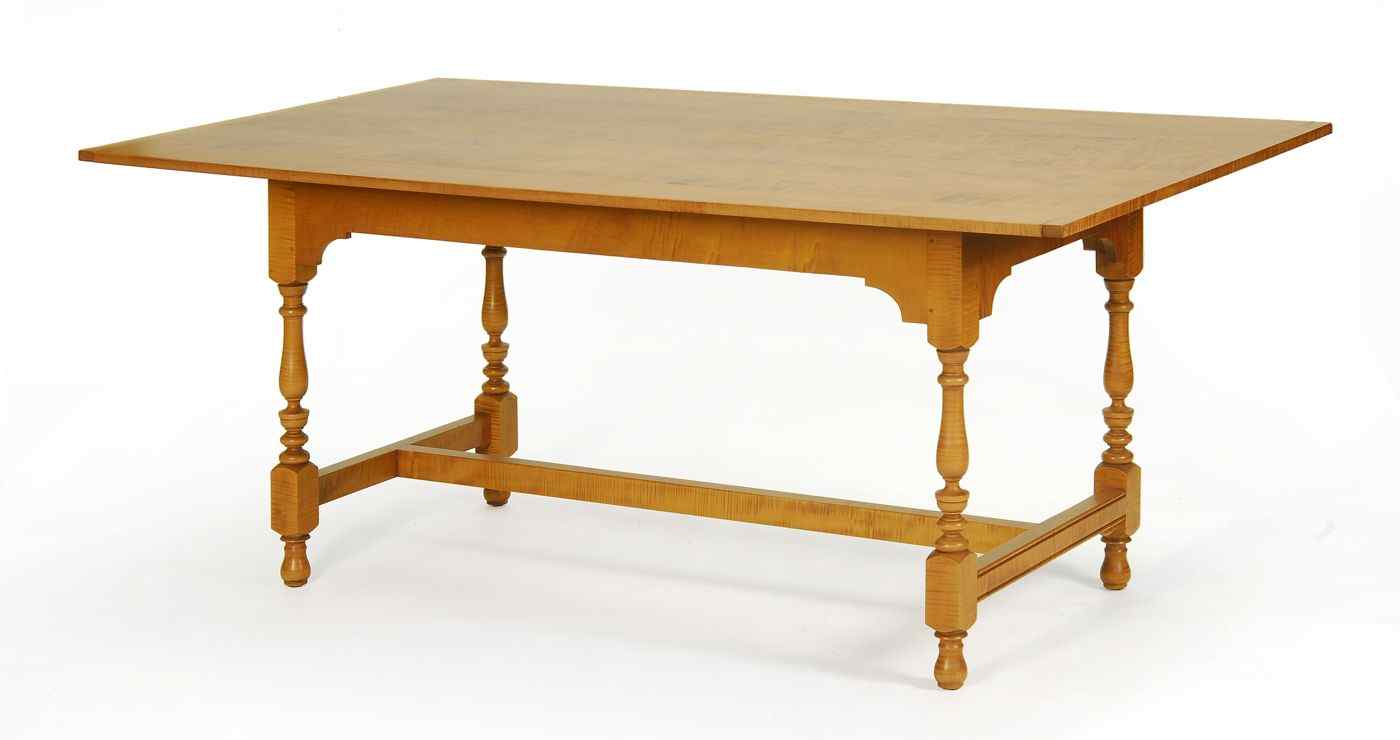 Appraisal: ELDRED WHEELER TRESTLE DINING TABLEIn tiger maple with breadboard ends